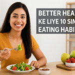 Indian woman smiling while eating a fresh green salad at a table with fruits, promoting better health and simple eating habits.